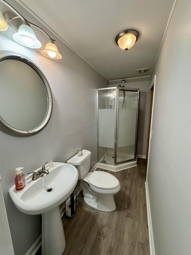 full bathroom featuring toilet, visible vents, a shower stall, and wood finished floors