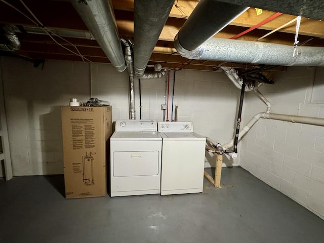 unfinished basement featuring washer and dryer and concrete block wall