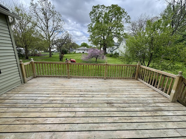 wooden terrace with a lawn