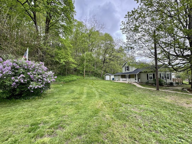 view of yard featuring a garage and a porch