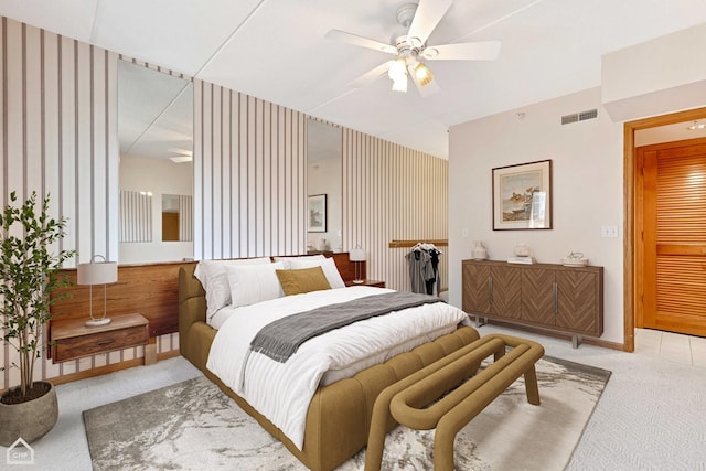 bedroom with carpet, visible vents, ceiling fan, and baseboards