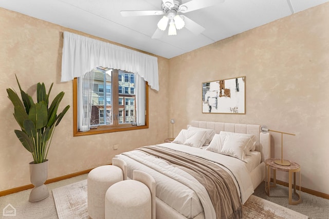 bedroom with ceiling fan, carpet, and baseboards