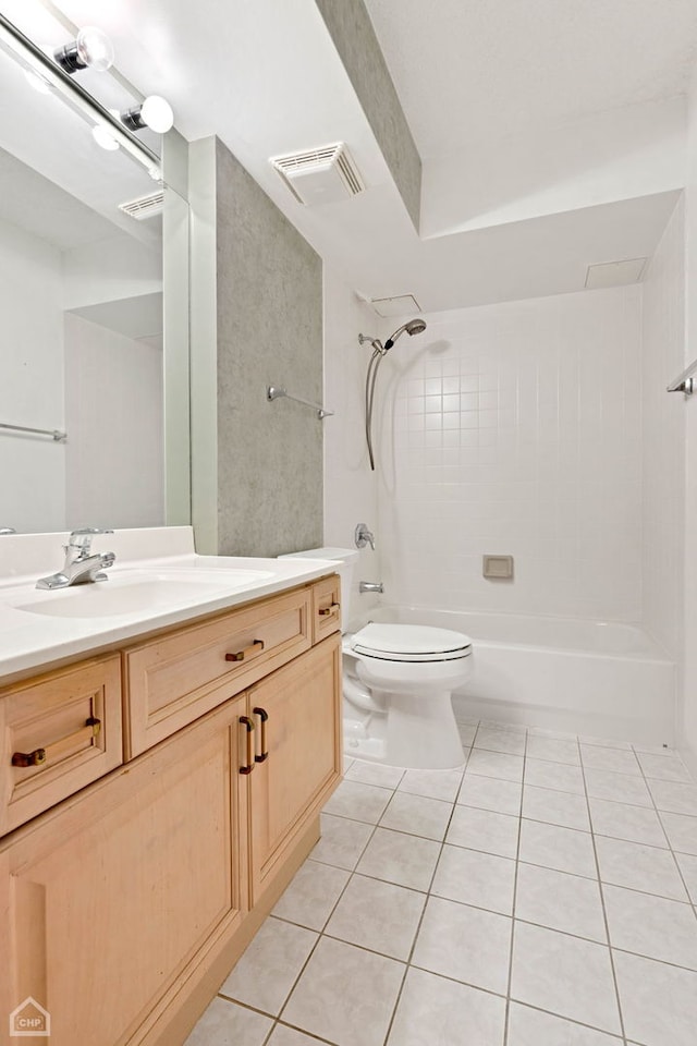 bathroom with tile patterned flooring, toilet, vanity, visible vents, and tub / shower combination