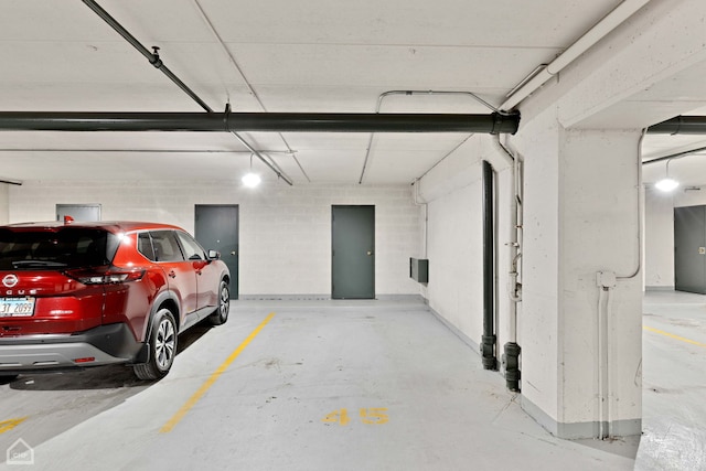 parking garage featuring concrete block wall