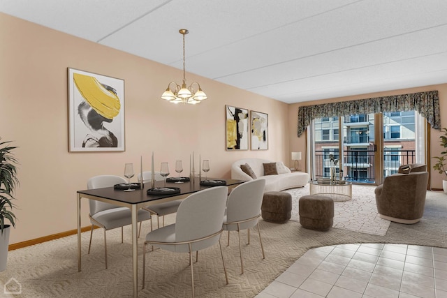 carpeted dining area with a notable chandelier, baseboards, and tile patterned floors