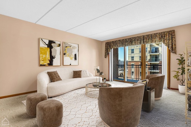 living room featuring carpet and baseboards