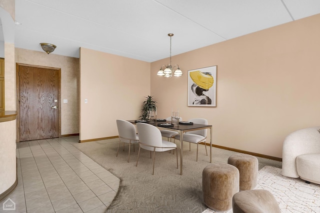 dining area with light colored carpet, baseboards, and an inviting chandelier