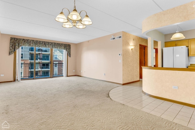 unfurnished room featuring light carpet, light tile patterned floors, baseboards, and a notable chandelier