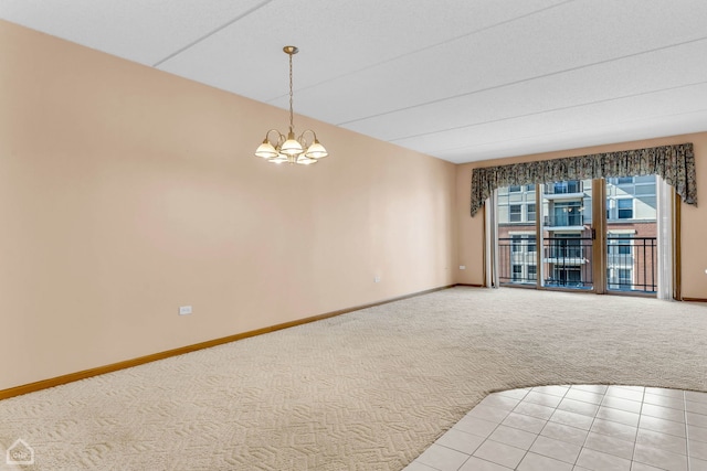 unfurnished room featuring light carpet, baseboards, and a notable chandelier