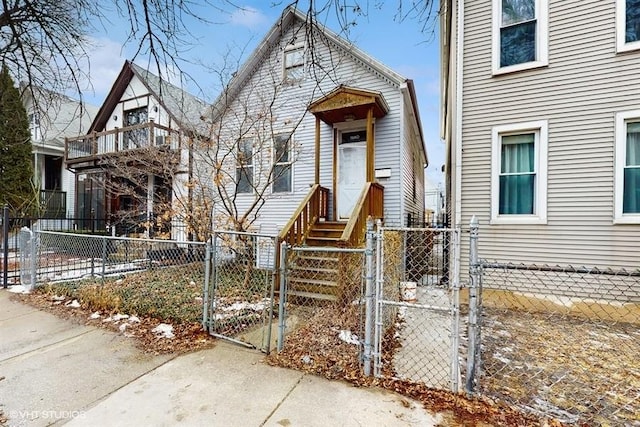 view of front facade with a fenced front yard and a gate