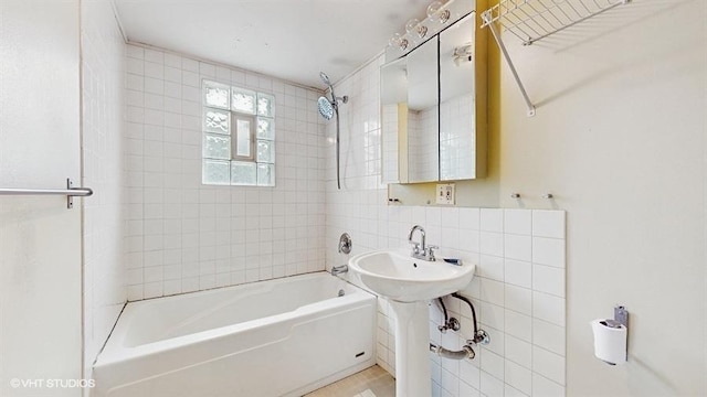 full bathroom with  shower combination, backsplash, and tile walls