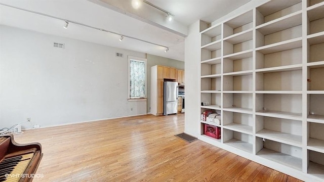 sitting room featuring light wood finished floors, visible vents, and rail lighting