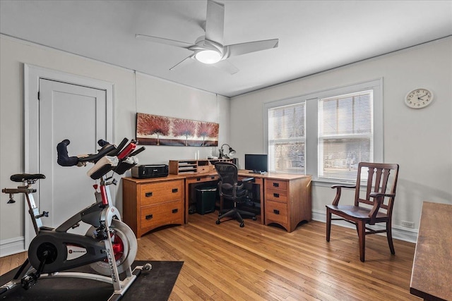 home office featuring baseboards, light wood-style flooring, and a ceiling fan