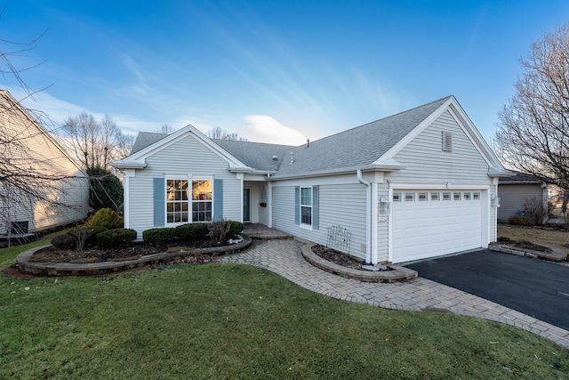 single story home featuring a shingled roof, a front yard, driveway, and an attached garage