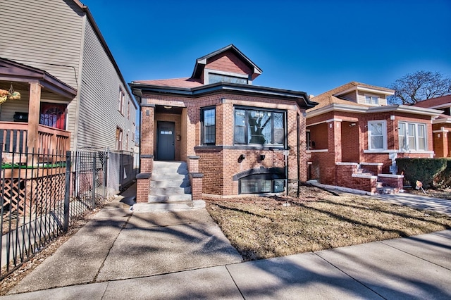 view of front facade featuring brick siding and fence