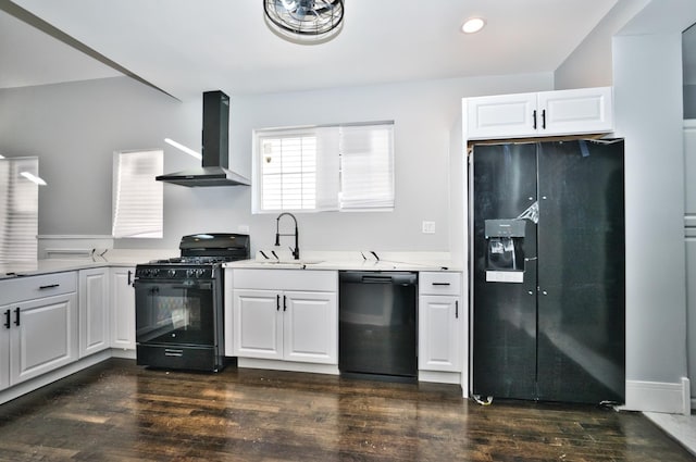 kitchen with a sink, light countertops, wall chimney range hood, black appliances, and dark wood finished floors