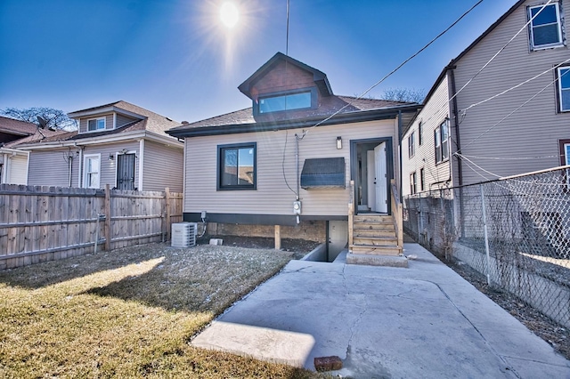 view of front of property featuring fence private yard and cooling unit