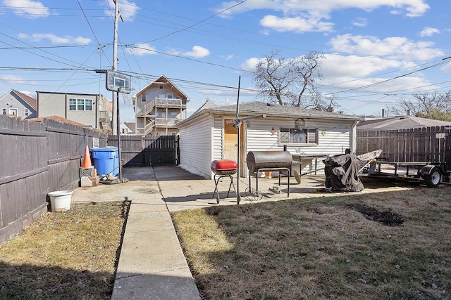 back of property with a fenced backyard, a patio, and a lawn