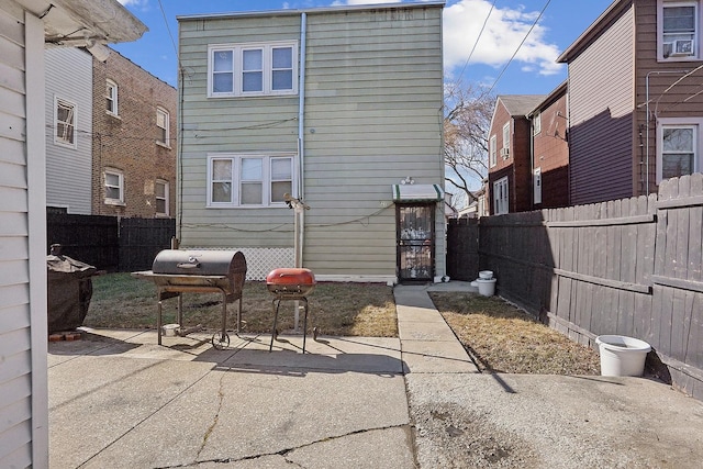 back of property with a patio area and a fenced backyard