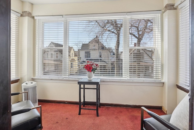 sitting room featuring carpet floors and baseboards