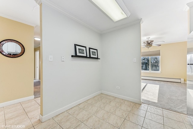 spare room with a baseboard heating unit, ornamental molding, baseboards, and a ceiling fan