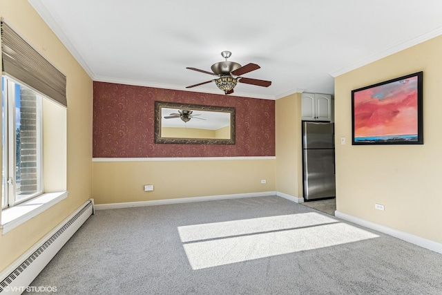 spare room featuring wallpapered walls, ornamental molding, baseboard heating, and light colored carpet