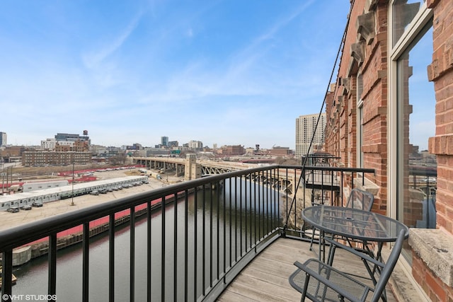 balcony featuring a water view and a view of city