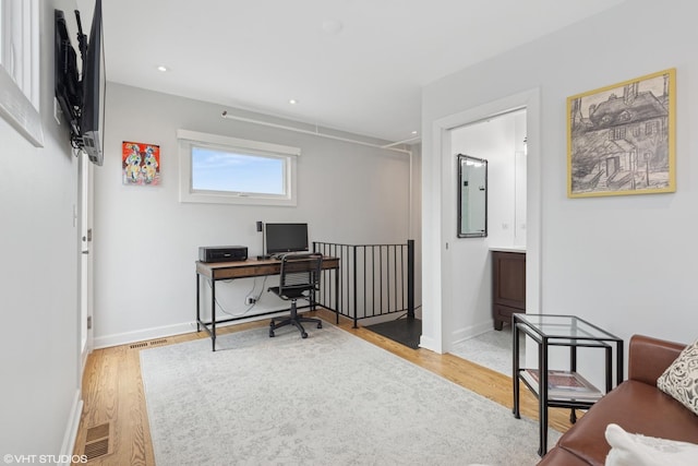 office space with light wood finished floors, recessed lighting, visible vents, and baseboards