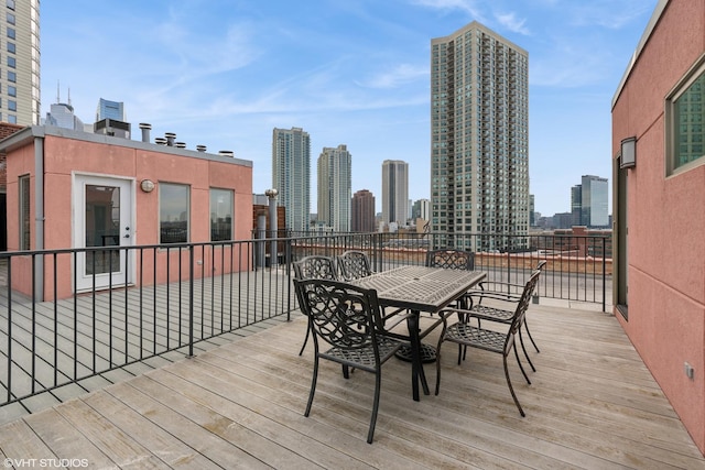 deck with a view of city and outdoor dining area