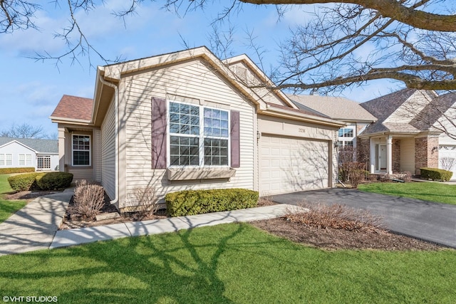 view of front facade with aphalt driveway, a garage, and a front yard