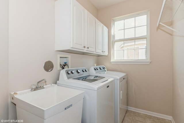 laundry room featuring cabinet space, independent washer and dryer, baseboards, and a sink