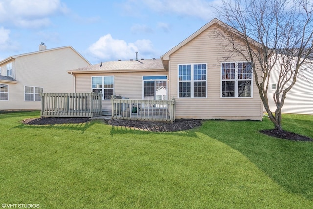 rear view of property featuring a lawn