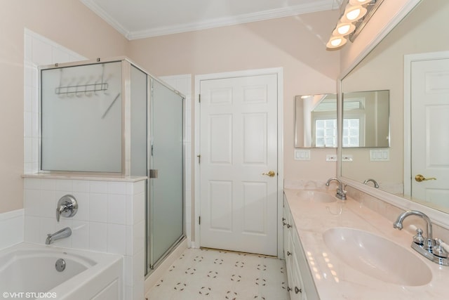 bathroom with a bath, a stall shower, crown molding, and a sink