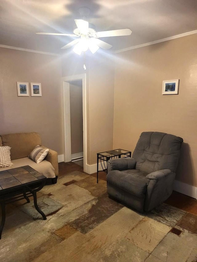 living area with ornamental molding, ceiling fan, and baseboards