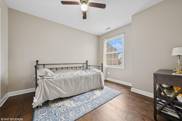 bedroom featuring ceiling fan, wood finished floors, visible vents, and baseboards