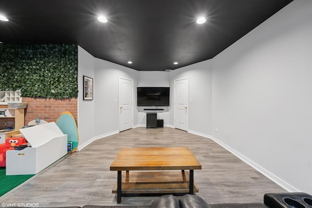 living room with baseboards, wood finished floors, and recessed lighting