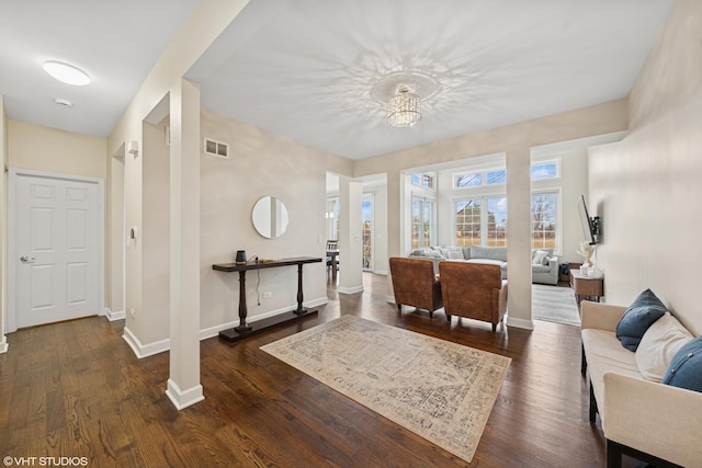 entrance foyer featuring dark wood-type flooring, visible vents, and baseboards