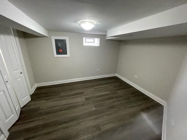 basement with dark wood finished floors and baseboards