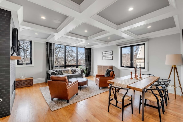 dining area with a wealth of natural light, coffered ceiling, and a fireplace