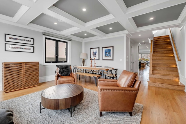 living area featuring light wood finished floors, stairs, coffered ceiling, and beamed ceiling