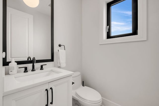 bathroom with toilet and vanity