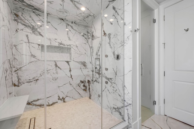 full bath featuring marble finish floor and a marble finish shower