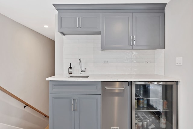 bar with wine cooler, wet bar, a sink, and decorative backsplash