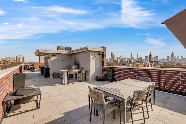 view of patio / terrace with outdoor dining area and a city view