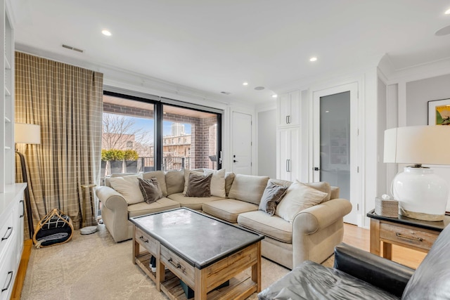 living area featuring ornamental molding and recessed lighting