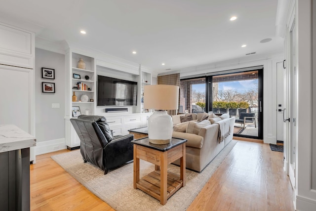 living area with built in features, recessed lighting, ornamental molding, light wood-type flooring, and baseboards