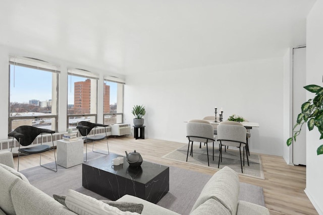 living area with a view of city and wood finished floors