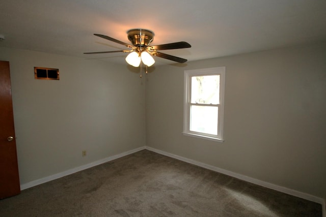 unfurnished room with a ceiling fan, baseboards, and carpet flooring