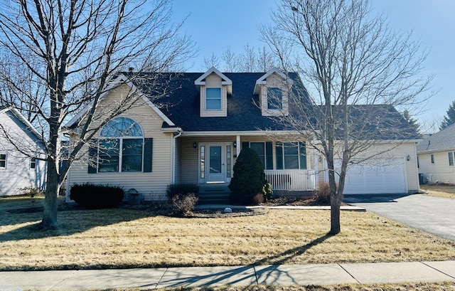 cape cod house with aphalt driveway, an attached garage, covered porch, and a front yard