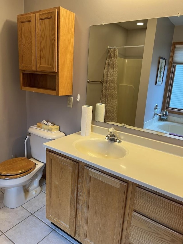 bathroom featuring tile patterned floors, toilet, a shower with shower curtain, and vanity